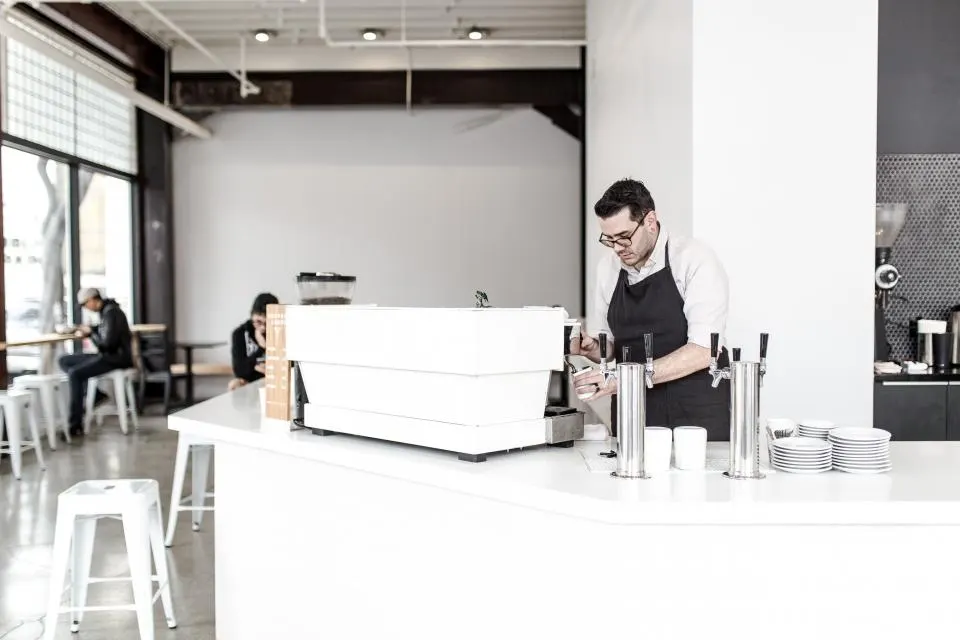 A barista working behind the counter of a café