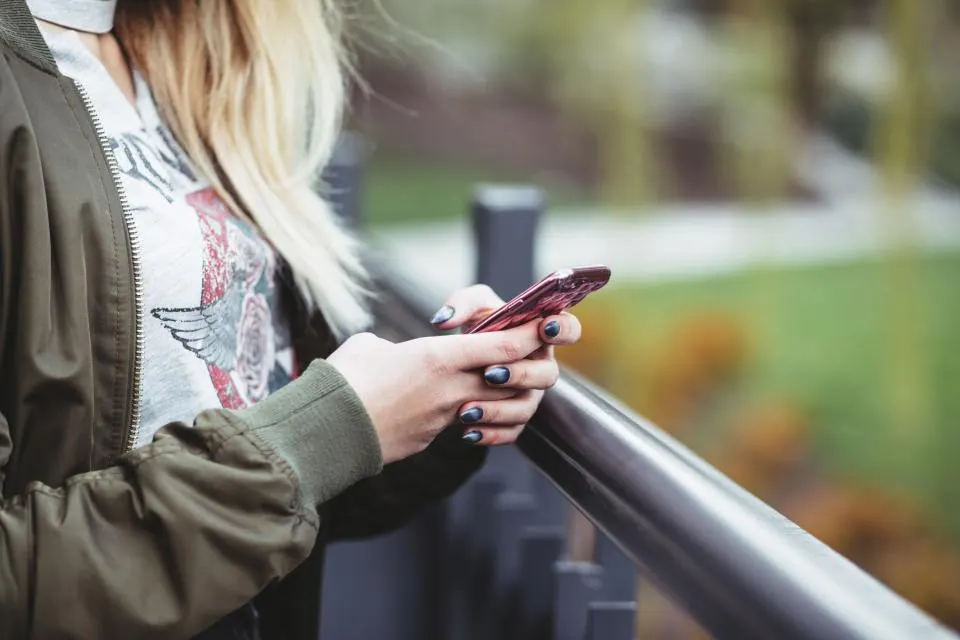 A person looking down at their phone