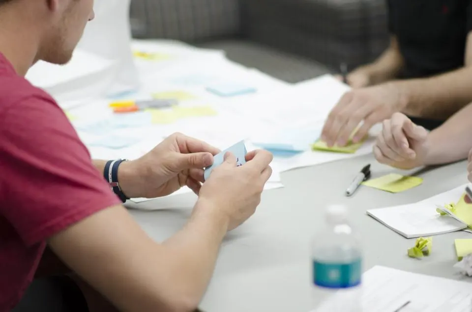 Colleagues going through papers together at a meeting table