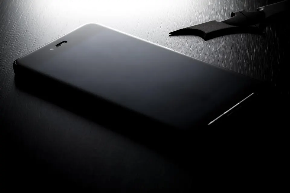 A phone lying face down in the dark